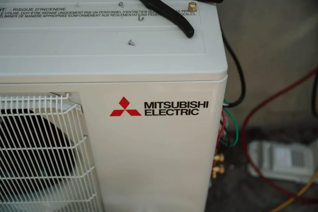 Close up of a Mitsubishi Electric condenser nameplate and wiring