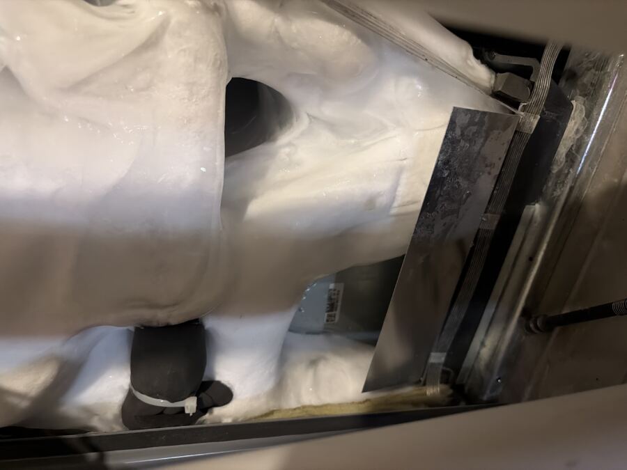 Heavy ice buildup inside an evaporator coil cabinet
